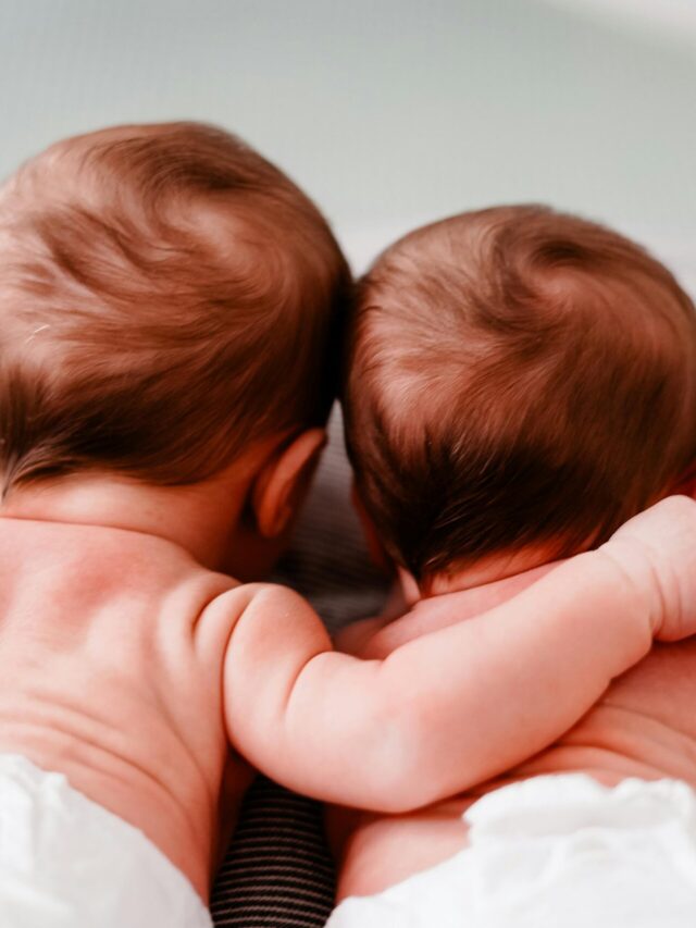 two baby twins lying face down